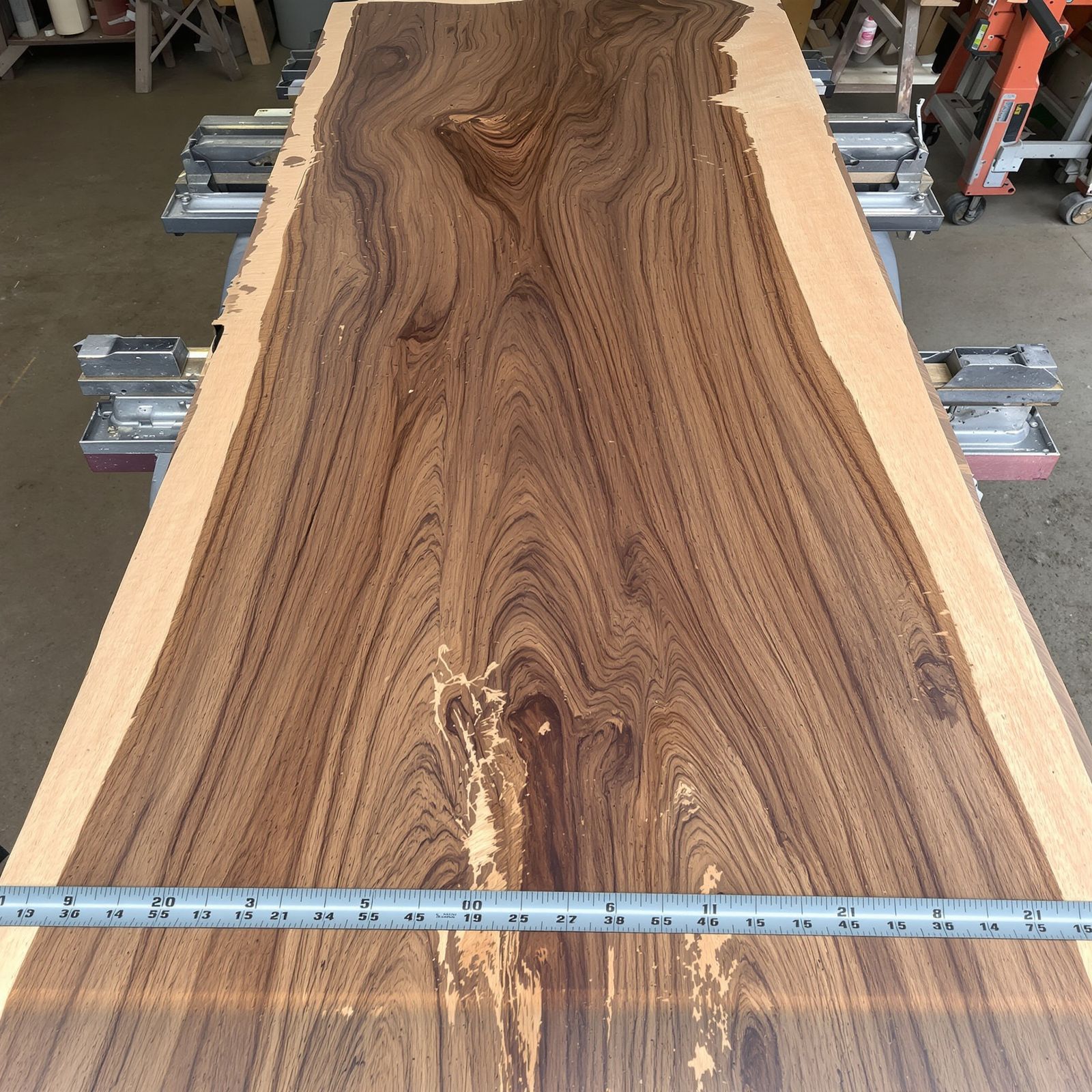 A close overhead of oiled walnut showing the grain and the natural edge